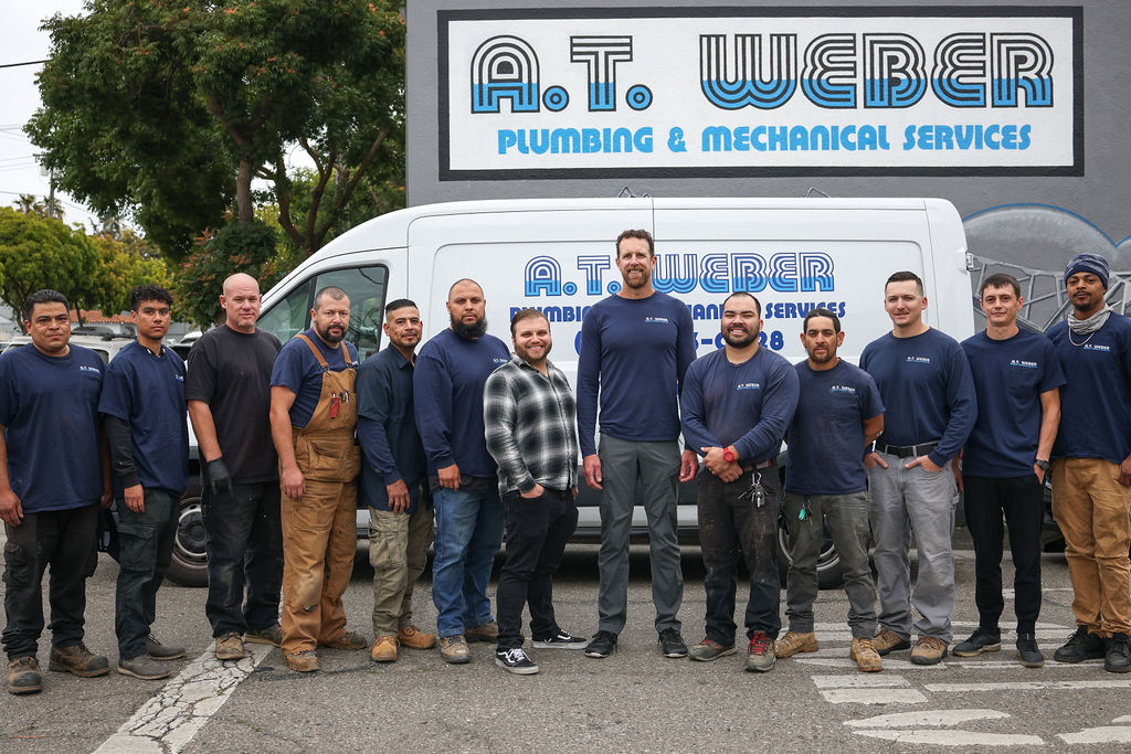 AT Weber Plumbing & Mechanical Services team standing in front of their branded service van