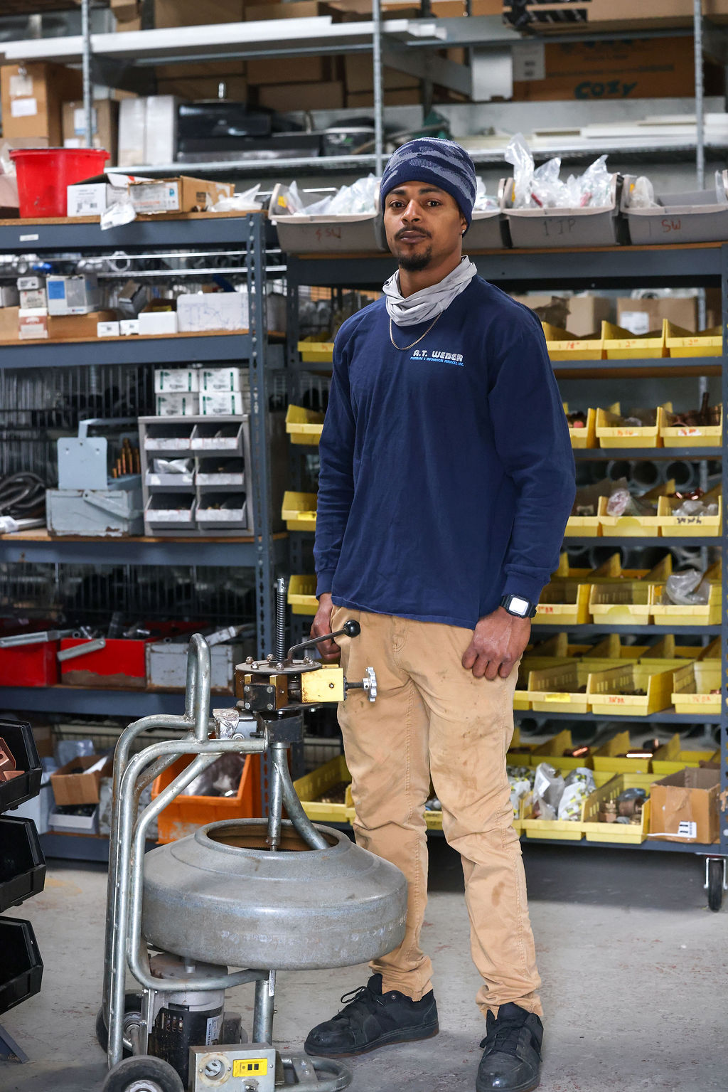 AT Weber technician with tankless water heater equipment